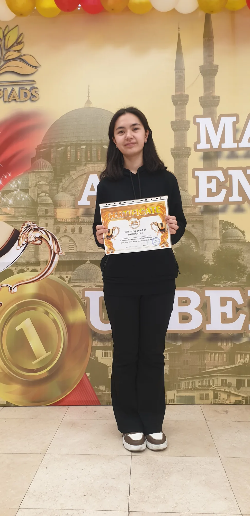 Muslima Ubaydillayeva with a certificate